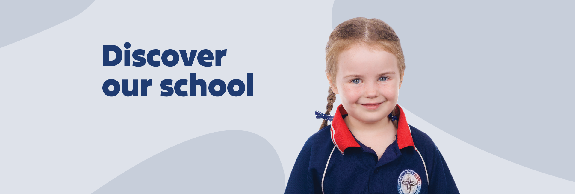 A girl smiling in a navy blue school uniform